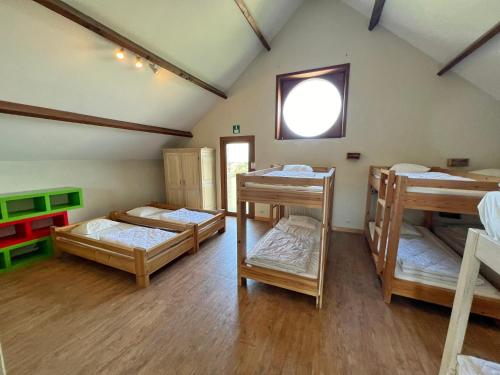 a room with four bunk beds and a window at La Recreation in Somme-Leuze