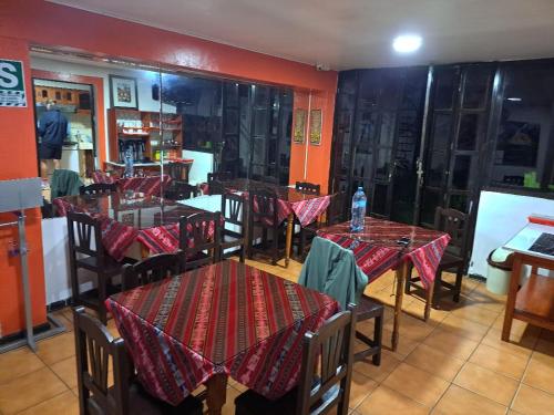 a restaurant with tables and chairs in a room at Mirador Backpackers B&B in Huaraz