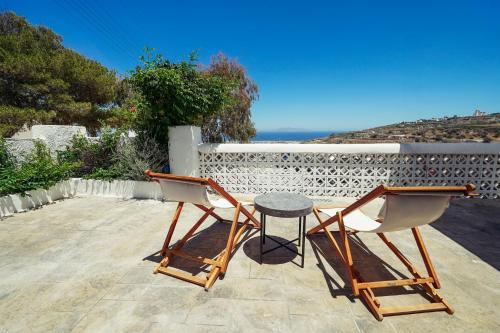 two chairs and a table on a patio at Dream Santo Villa in Vóthon