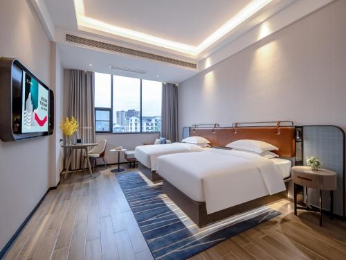 TV a/nebo společenská místnost v ubytování Echarm Hotel Hechi Bama Branch