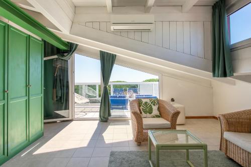 a living room with a couch and a table at Harvey Suites Hotel & Residence in Lido di Jesolo