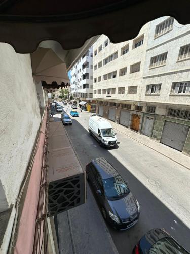a group of cars parked on a city street at Hôtel Nexus Budget in Al Hoceïma