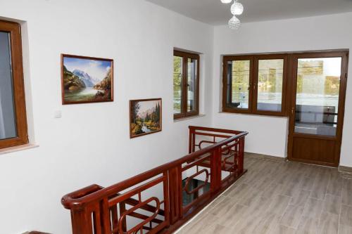 a living room with a staircase and windows at Vila Giovanni in Orşova