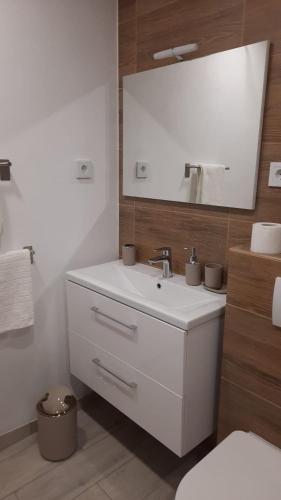 a bathroom with a white sink and a mirror at Apartments Ruzica in Makarska