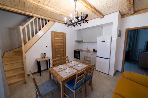 a kitchen and dining room with a table and chairs at Ostoja Tatary Agroturystyka in Tykocin