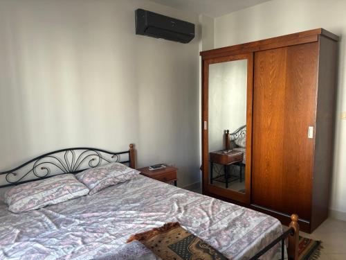 a bedroom with a bed and a dresser and a mirror at Amwaj north cost in El Alamein