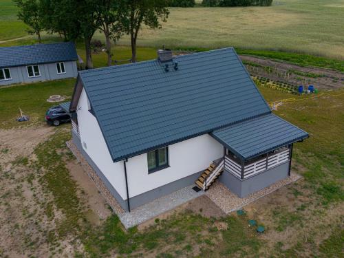 an overhead view of a small house with a green roof at Ostoja Tatary Agroturystyka in Tykocin