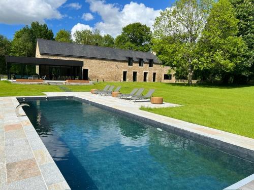 une piscine devant une maison dans l'établissement Magnifique ferme rénovée, à La Landec