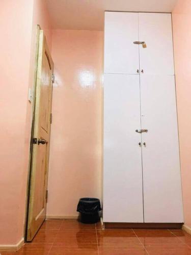a room with a white closet and a door at Fully furnished 3 Bedrooms 2 storey House!! in Dipolog