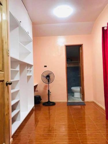 a room with a fan and a room with a toilet at Fully furnished 3 Bedrooms 2 storey House!! in Dipolog