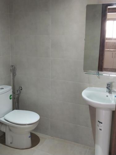 a bathroom with a toilet and a sink at Appartement Miftah Sahill 1 haut Standing in Agadir