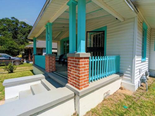 a front porch of a house with blue columns at 2 BR Quaint Private Bungalow NR Downtown & Beaches in Pensacola