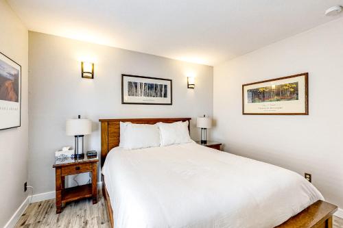 a bedroom with a large white bed and two lamps at Elegant Escape in Park City