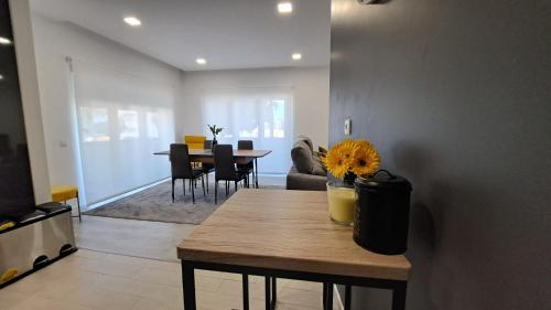 a living room with a table and a dining room at Casa Sol em Castelo Branco in Castelo Branco