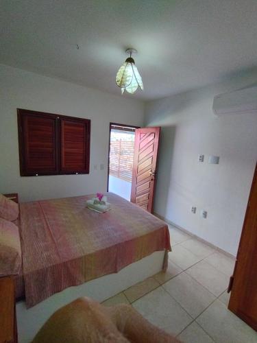 a bedroom with a large bed and a window at Casa Grande in Camocim