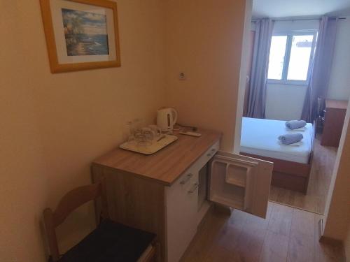 a room with a desk and a bed in a room at Apartmani Fani 2 min walking from sea in Orebić