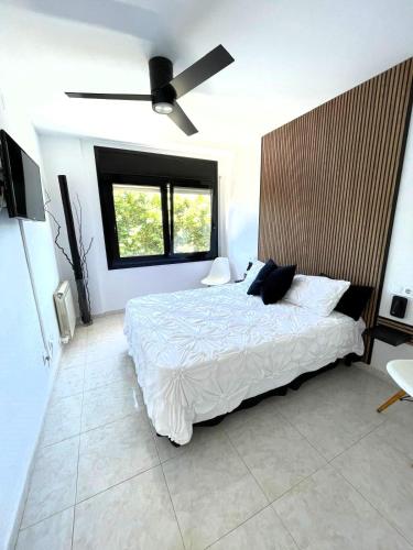 a bedroom with a bed and a ceiling fan at Vivalidays Yolanda in Calella