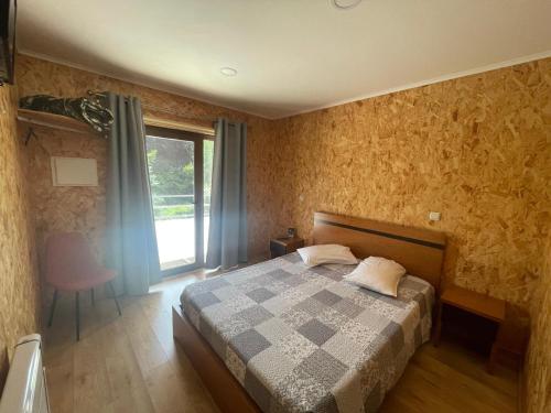 a bedroom with a bed and a window at Quinta de Fundões in Geres
