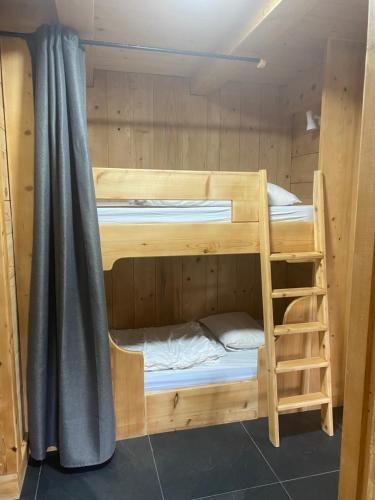 a couple of bunk beds in a cabin at La Ferme des Georgières "Séjour en tout compris" in Notre-Dame-de-Bellecombe