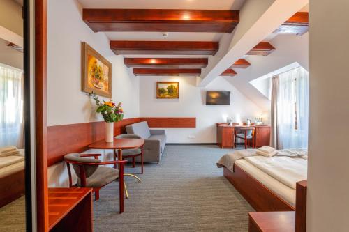 a hotel room with a bed and a desk at Malachit Karpacz SPA Hotel in Karpacz