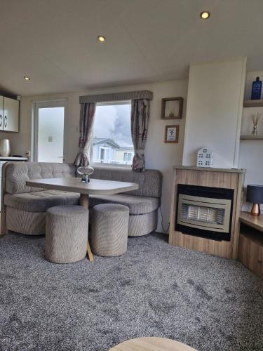 a living room with a couch and a table at Haven Skegness 20 Donna Nook in Skegness