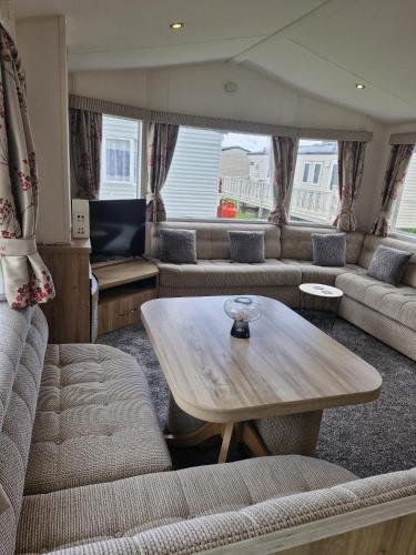 a living room with a couch and a table at Haven Skegness 20 Donna Nook in Skegness