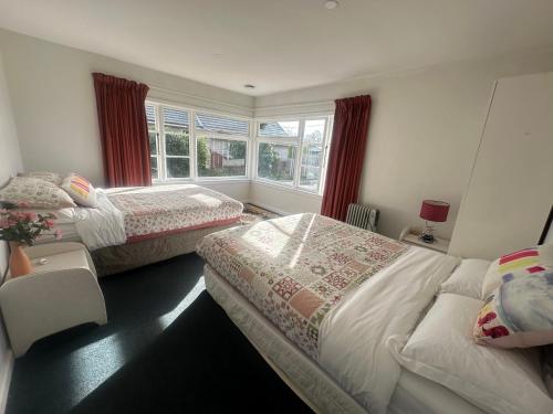 a bedroom with two beds and a window at Sunny House with 5 Bedrooms(near airport) in Christchurch