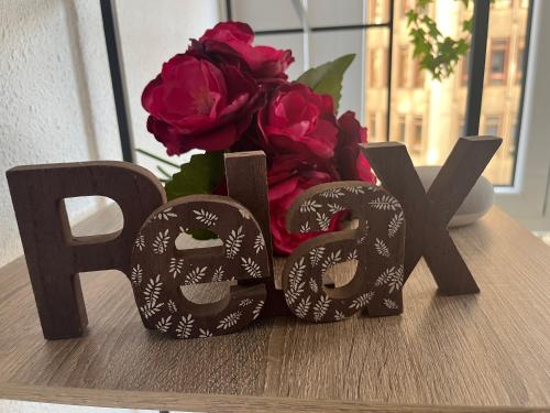 a table with two masks and a vase of flowers at Pension Angelines, Sneuu Hostel Santander in Santander
