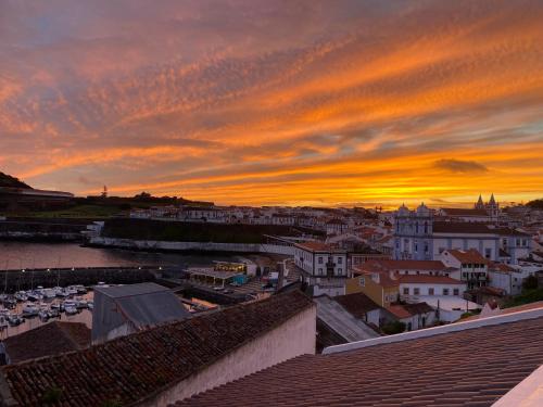 a view of a city at sunset at Villa Atlantica Apartments in Angra do Heroísmo