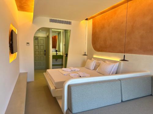 a bedroom with a bed with two towels on it at Yperia Hotel in Aegiali