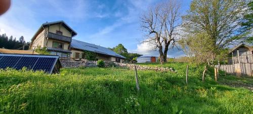 a farm with a house and a field of grass at La Petite Echelle in Rochejean