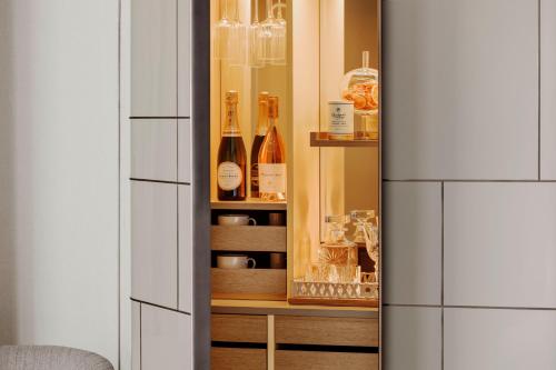 a cupboard filled with bottles and glasses at One&Only One Za'abeel in Dubai