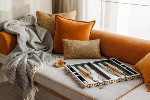 a tray of knives on a couch with a blanket at One&Only One Za'abeel in Dubai
