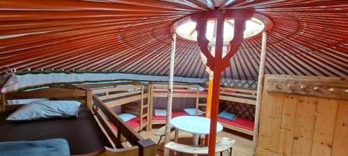 a room with two bunk beds and a red ceiling at La Petite Echelle in Rochejean