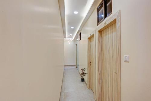 a hallway with a wooden door in a room at Hotel O Kiwi International in Mumbai