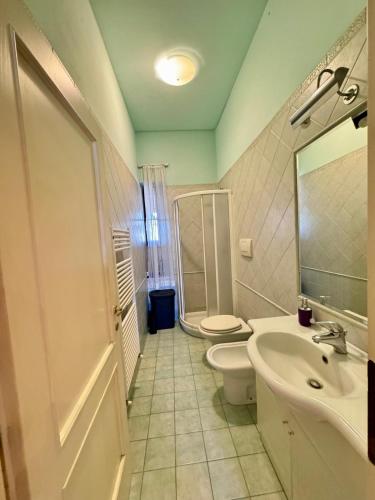 a bathroom with a toilet and a sink and a shower at Al Civico 15 in Grosseto