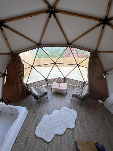 a room in a tent with a white rug at Antikhouse Bungalow&Cafe in Akcaabat