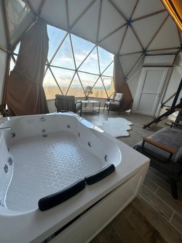 a bath tub in a yurt with a view at Antikhouse Bungalow&Cafe in Akcaabat
