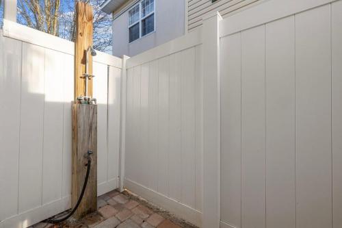 a white fence next to a house at Bummer Busters in Myrtle Beach