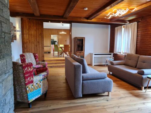 a living room with couches and chairs and a fireplace at Der Kristall by Globalimmoservice in Bad Kleinkirchheim