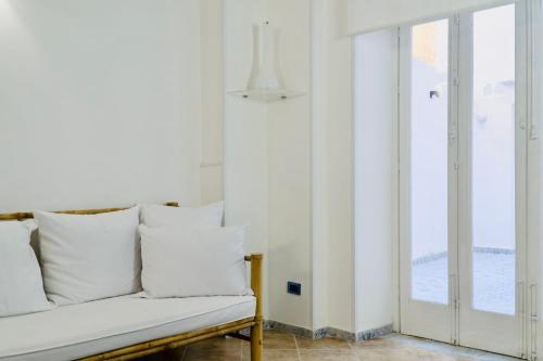 a white couch in a room with a window at Butera Apartments Luxury in Palermo