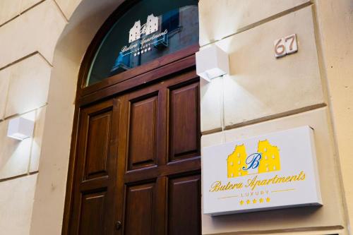 a door to a building with a sign on it at Butera Apartments Luxury in Palermo