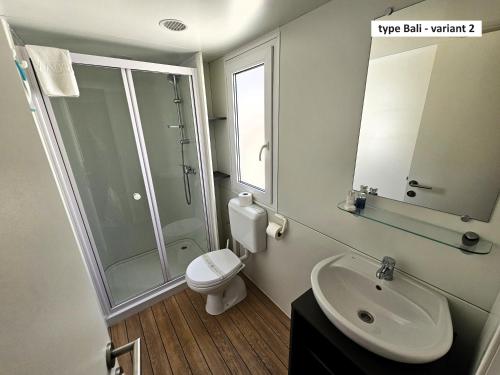 a bathroom with a sink and a shower and a toilet at Amadria Park Camping Trogir - Mobile Homes 2 in Seget Vranjica