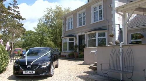 a black car parked in front of a house at Meifod House in Caernarfon