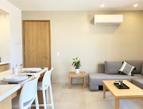 a living room with a couch and a table at Levitat Hunah in Playa del Carmen