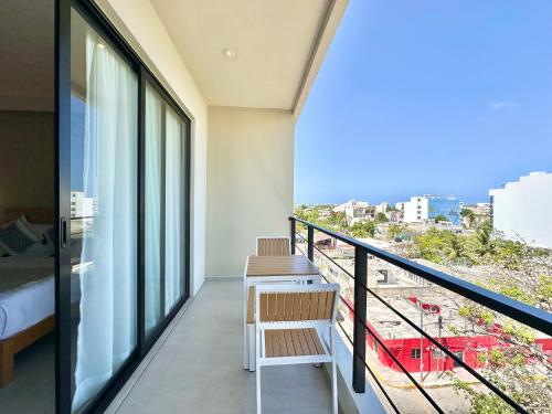 a balcony with a bed and a view of the city at Levitat Hunah in Playa del Carmen