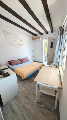 a bedroom with a bed and a table at Apartment Max in Borovići