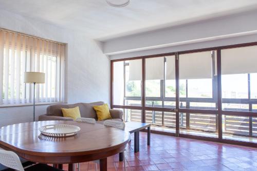 a living room with a couch and a table at T3 Casa Central in Sesimbra