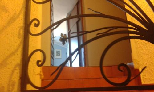 a metal sculpture of a plant in front of a mirror at Apartmani Vila Marija in Budva