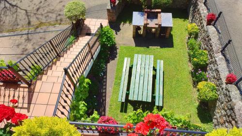 a view of a park with a bench and flowers at Casa de la Fuente Santillana del Mar in Santillana del Mar